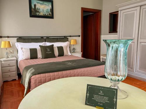 a bedroom with a bed with a vase on a table at Villa Zane in Treviso