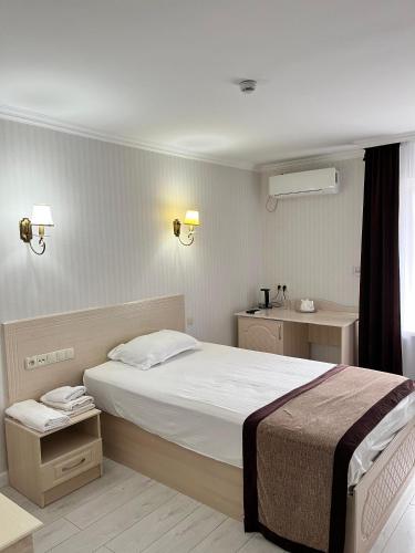 a bedroom with a large bed in a room at Турист in Astana