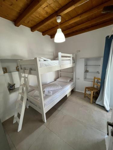 a bedroom with two bunk beds in a room at La Casa Bianca Naxos in Vívlos
