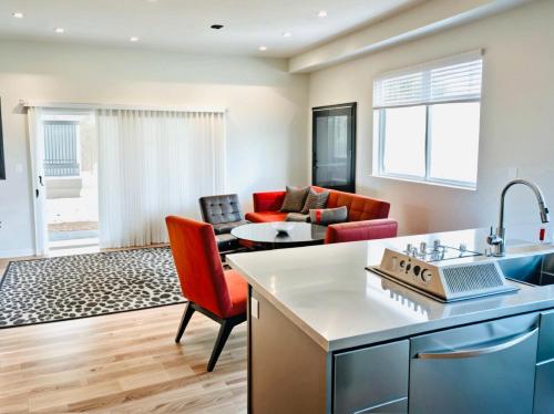 a kitchen and living room with a couch and a table at Hollywood Boutique Residences with Free Parking in Los Angeles