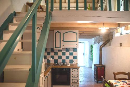 a kitchen with a staircase in a tiny house at Borgo di Quarazzana holiday house with pool for groups Tuscany in Agnino