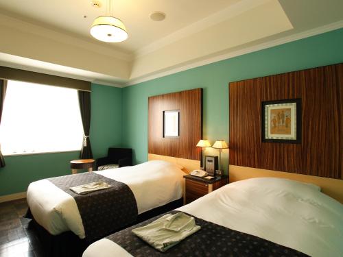 Cama ou camas em um quarto em Hotel Monterey La Soeur Fukuoka