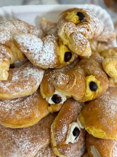 a pile of pastries covered in powdered sugar at Maison De luxe in Pompei