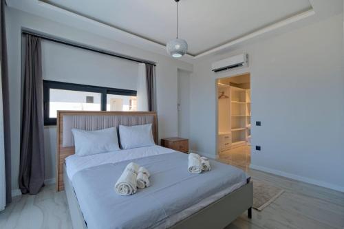 a bedroom with a bed with two stuffed animals on it at Villa DeFnE Fethiye in Fethiye