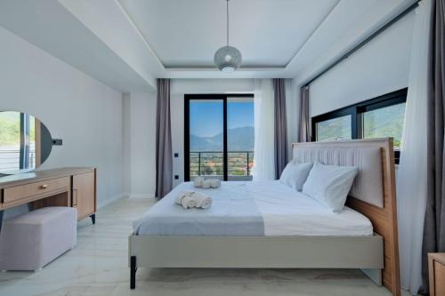 a bedroom with a bed with two teddy bears on it at Villa DeFnE Fethiye in Fethiye