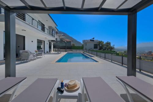 a house with a swimming pool on a roof at Villa DeFnE Fethiye in Fethiye