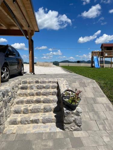 a bowl of flowers sitting on a stone walkway at Apartment9B with amazing view in Krško