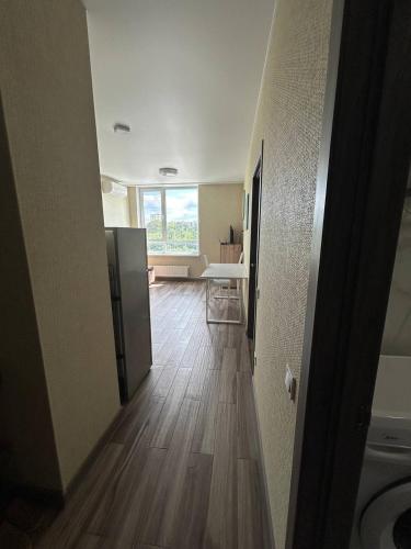 an empty room with a wooden floor and a window at Республіка 145 in Kyiv