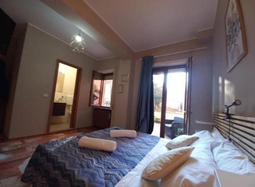 a bedroom with a large bed with two pillows on it at Easy home in LʼAquila