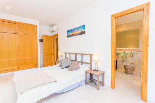 a bedroom with a bed and a large mirror at Finca Isabel y Guillermo con posibilidad de piscina climatizada in Sineu