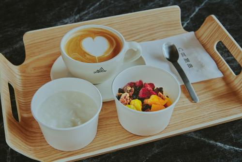 a tray with two cups of coffee and a bowl of fruit at fav Hida Takayama in Takayama