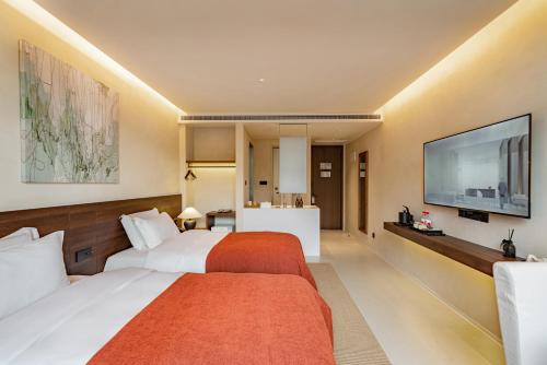 Letto o letti in una camera di Terra Art Garden Hotel