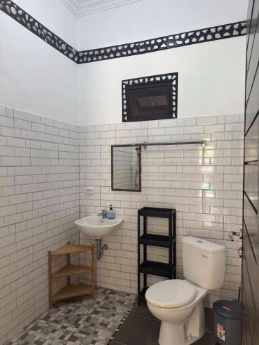 a bathroom with a toilet and a sink at The Paradise Bali in Badung