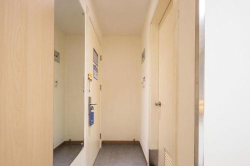 an empty hallway with two doors and a hallway at 7 Days Inn Suzhou Mudu Ancient Town Kaima Auto Market in Suzhou