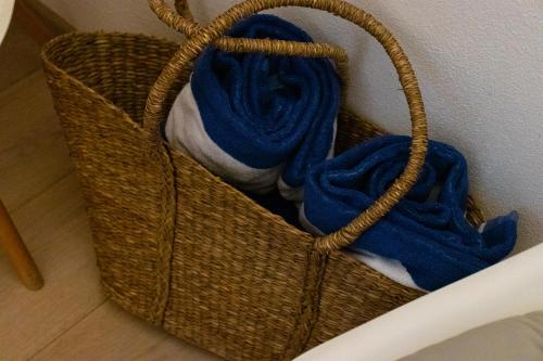 a basket with blue towels in it on the floor at Manna Blue Sky - Exclusive Rooms in Barletta