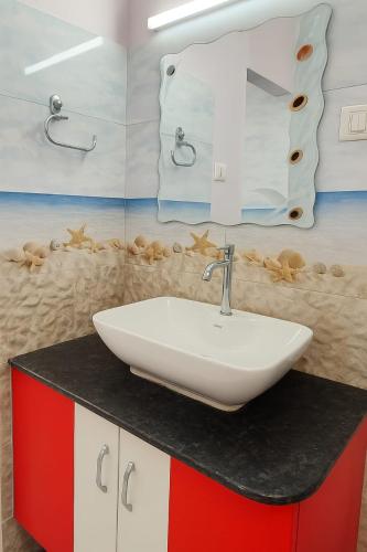a bathroom with a sink and a mirror at The Elite Villa 2 Bhk in Panchgani