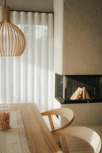 a dining room table with two chairs and a light fixture at Chalet Herol in Luson
