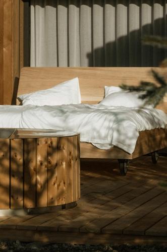 a bedroom with a wooden bed and a wooden table at Chalet Herol in Luson