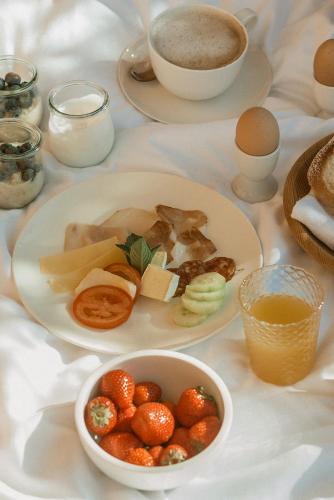 a table with plates of food and a cup of coffee at Chalet Herol in Luson