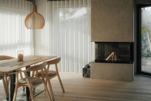 a dining room with a table and a fireplace at Chalet Herol in Luson