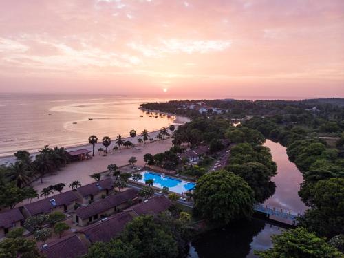 an aerial view of the beach and ocean at sunset at Amethyst Resort Passikudah in Pasikuda