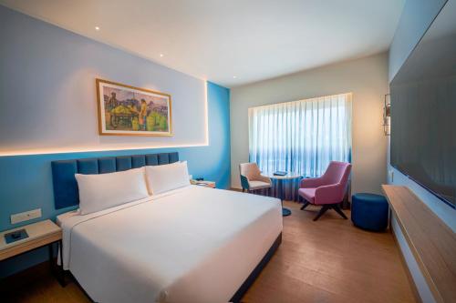 Sarovar Portico Sriperumbudurにあるベッド