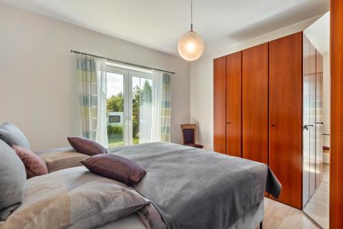 a bedroom with a large bed and a large window at Ferienwohnung Lahnurlaub in Huttenberg