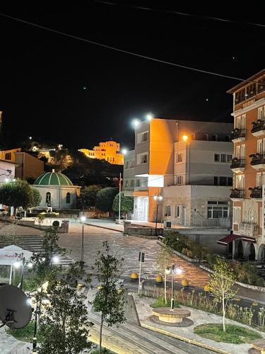 a city street at night with buildings and lights at Stone Bazaar Villa in Krujë