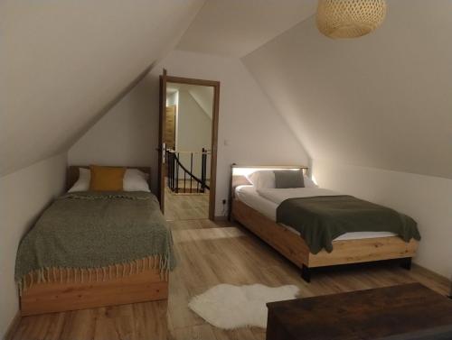 a bedroom with a bed and a mirror at Chalúpka pod Hradom Lednica 