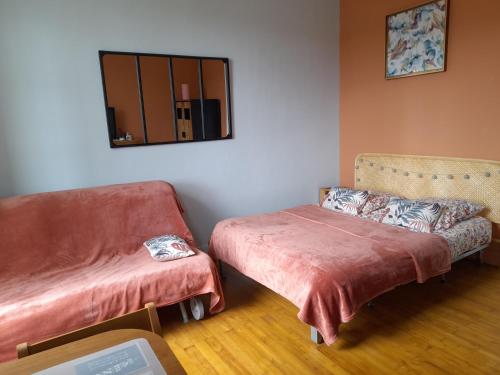 a living room with a couch and a chair at Les roses à la plage in Veules-les-Roses