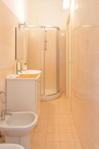a bathroom with a shower and a toilet and a sink at Via Milano 67 in Porto SantʼElpidio