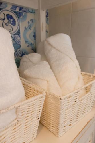 two baskets of towels on a counter in a bathroom at Manna Blue Sky - Exclusive Rooms in Barletta