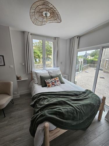 a bedroom with a large bed and a window at Studio indépendant Le Vast in Le Vast
