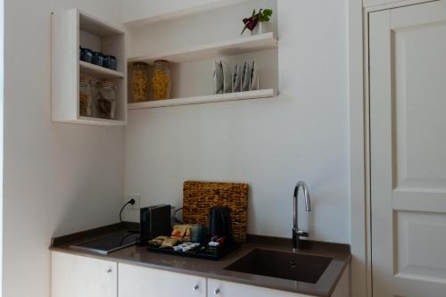 a kitchen with a sink and a counter with a sink at Manna Blue Sky - Exclusive Rooms in Barletta