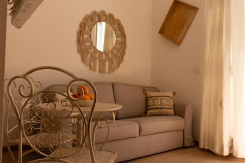 a living room with a couch and a mirror at Manna Blue Sky - Exclusive Rooms in Barletta