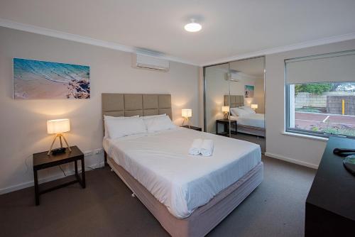 a bedroom with a large bed and a window at Coastal Elegance Relaxed Stay in Broadwater in Broadwater