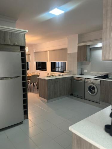a large kitchen with a stove and a dishwasher at Lazuli Skyline & Sea View Penthouse in Larnaca