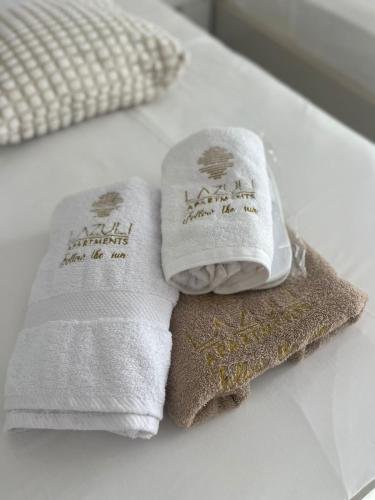 two towels sitting on top of a bed at Lazuli Skyline & Sea View Penthouse in Larnaca