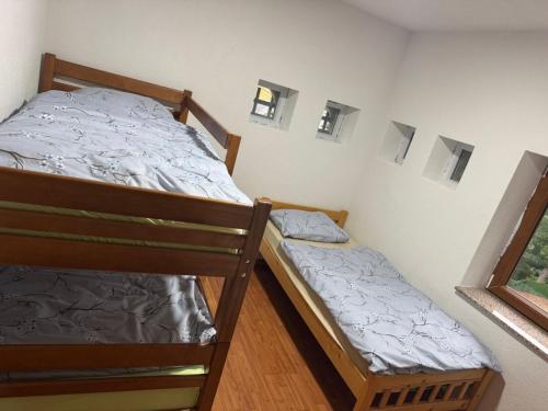 a bedroom with two bunk beds and a window at Kulla Guest House in Peje