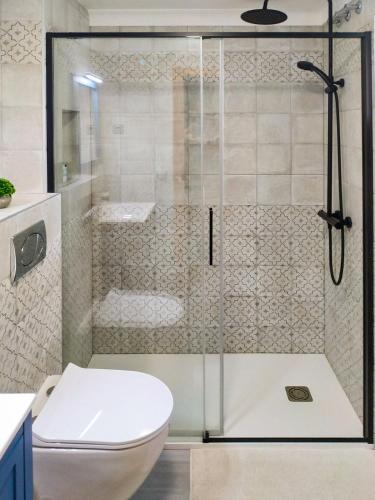 a bathroom with a shower with a toilet and a glass door at Apartment Viñamar 6 La Mata in La Mata