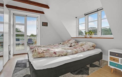 a bedroom with a bed in a room with windows at Cozy Home In Ebeltoft With Wifi in Ebeltoft
