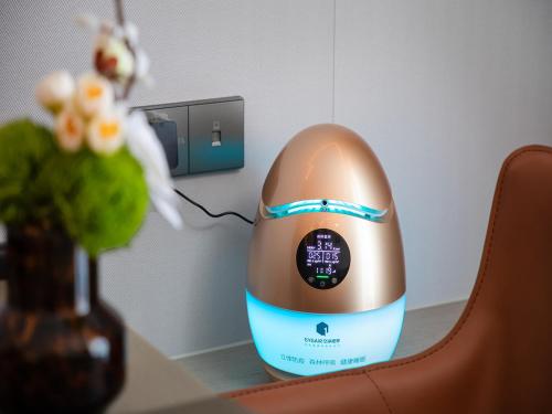 an egg sitting on a table next to a vase at Kunshan Kasion Hotel in Kunshan