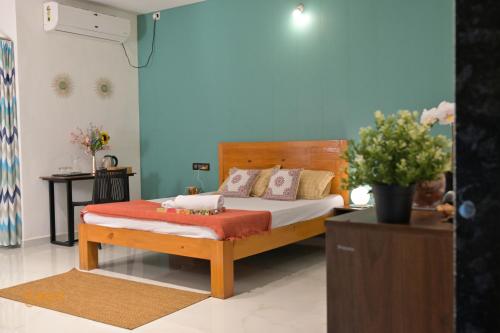 a bedroom with a bed in a room with blue walls at Euphoria Farmstay Pure Veg Khopoli in Āmbavna