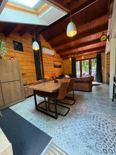 a living room with a table and a couch at Chalet 9 La Boverie in Rendeux