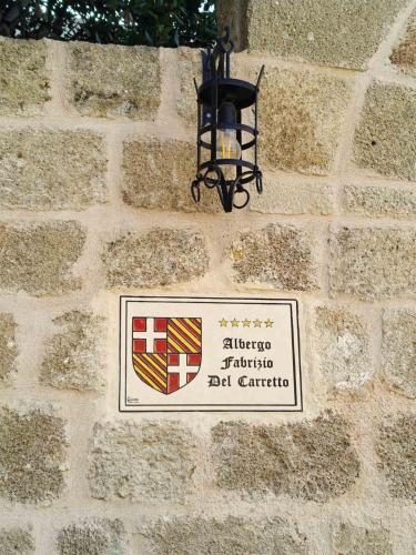 a sign on a brick wall with a light on it at Fabrizio del Carretto in Rhodes Town