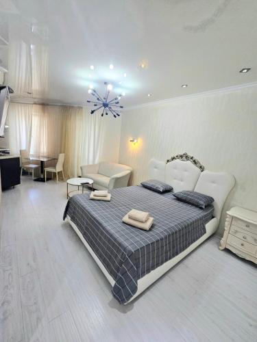 a bedroom with a large bed and a living room at ERA RENT Apartments in Chişinău