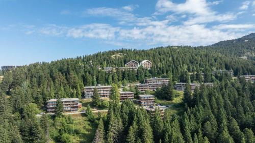 a resort in the middle of a forest of trees at V du Bachat - JOUBARDES A15- 6 PERS in Chamrousse