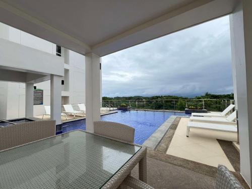 a house with a glass table and a swimming pool at Oceanview Condo in Boracay in Boracay