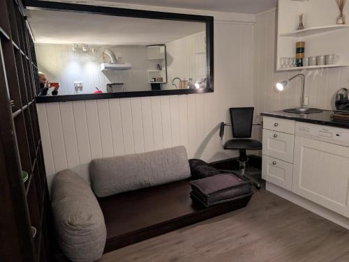 a living room with a couch and a mirror at Close to Karmøy and Haugesund airport in Karmøy