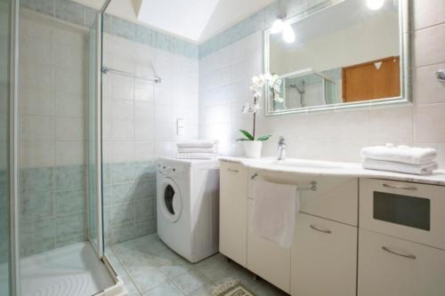 a bathroom with a washing machine and a shower at VILLAS CARISMA - Natural Style Villas for 14 people in Sivota